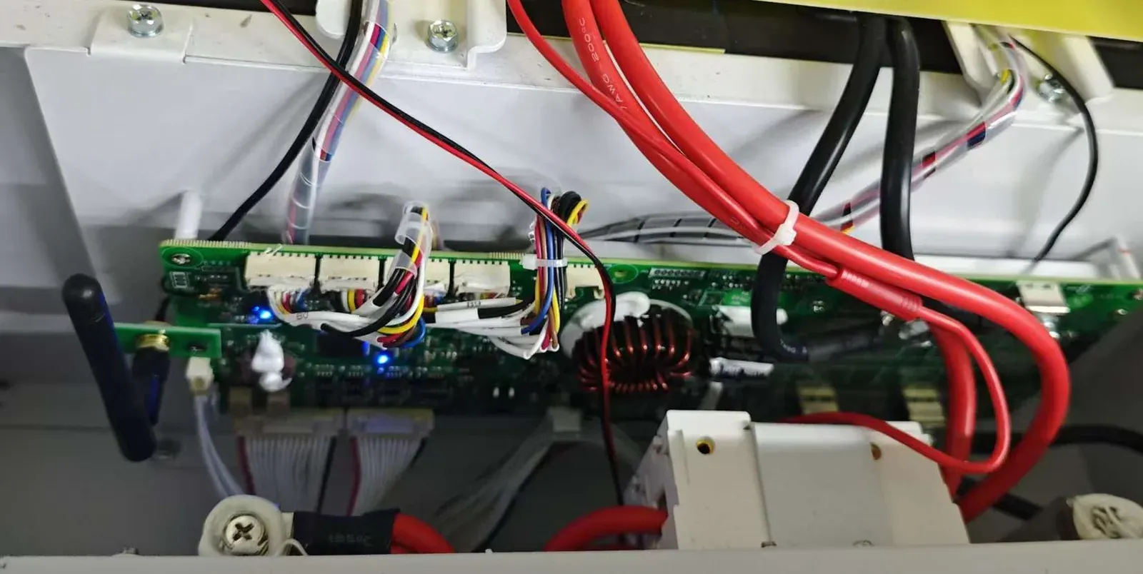 BMS control board with WiFi antenna module and wiring harness inside the battery pack